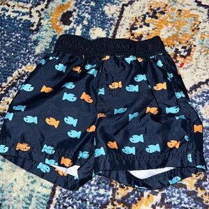 Gymboree 12/18 navy swim trunks with blue & orange fish. VGUC.